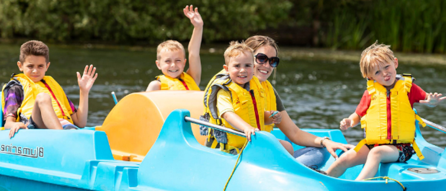 Family enjoying the lake in a small boat