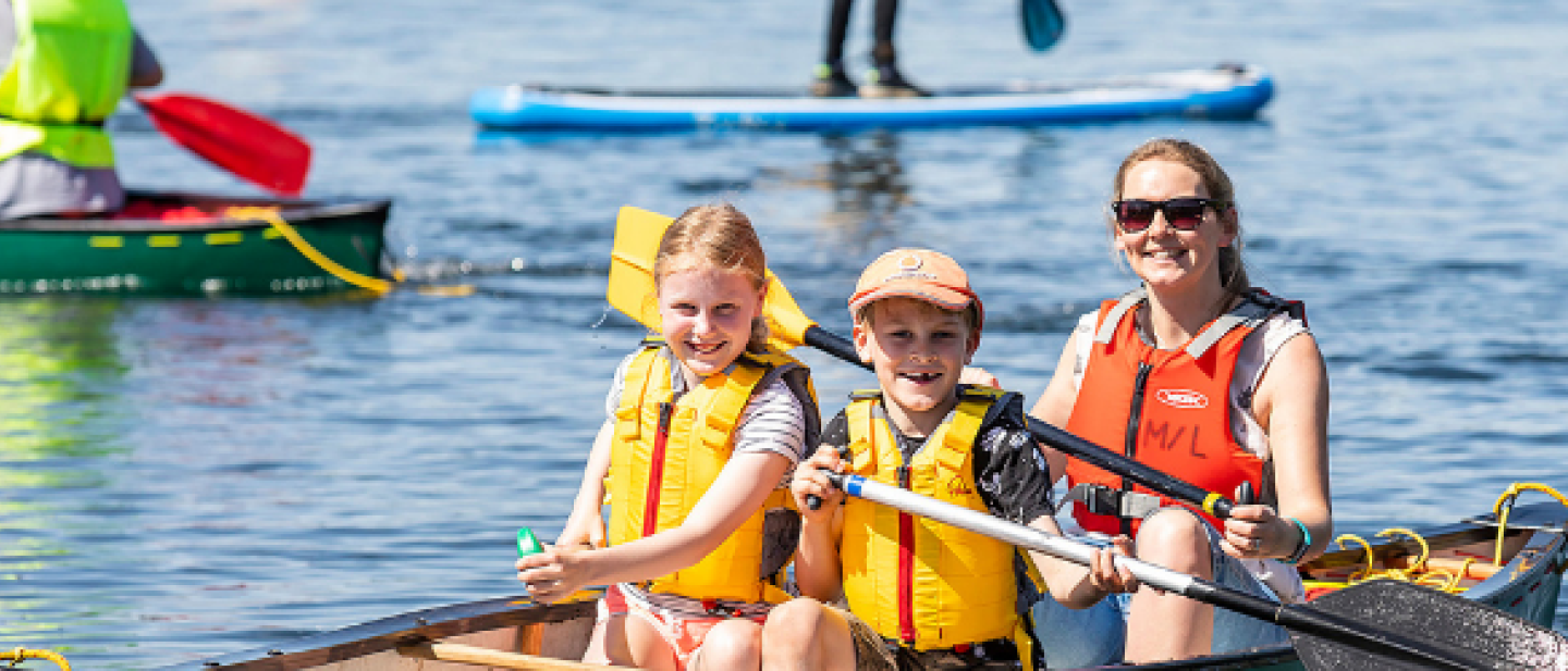 Family enjoying the lake on a canoe