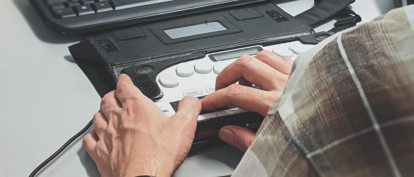 A man with visual impairments using a screen reader to access the website 